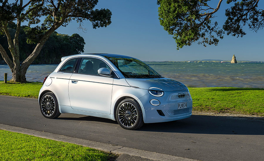 Blue Fiat hatch parked by the ocean
